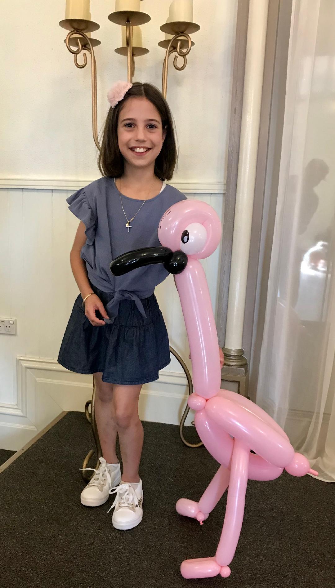 Children enjoying balloon creations at a corporate fete